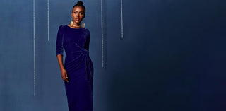 Woman wearing a velvet blue dress, perfect for parties and christmas events.